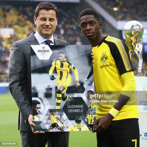 Ousmane Dembele of Dortmund poses with DFL CEO Christian Seifert and his 'Rookie 2017' award prior to the DFL Supercup 2017 match between Borussia...