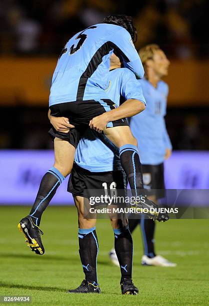 Uruguayan national team football players Maximiliano Pereira and Alvaro Gonzalez celebrate after defeating Colombia in their FIFA World Cup South...