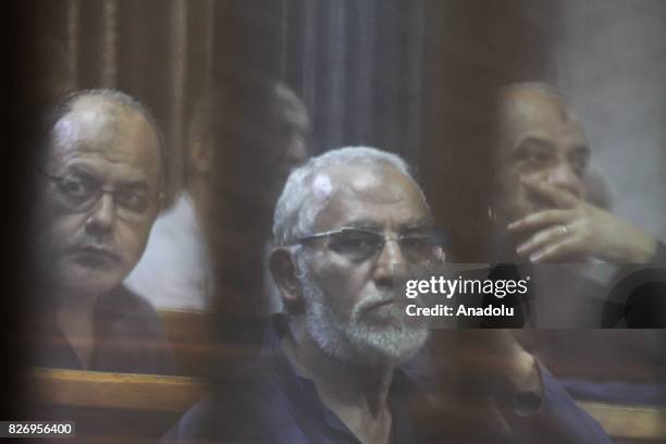 General Guide of the Egyptian Muslim Brotherhood Mohammed Badie and additional 21 defendants attend a trial session behind a cage at the Cairo Police...