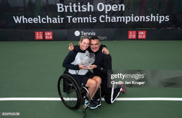 Lucy Shuker of Great Britain and Stephane Houdet of France pose with the mixed doubles winning trophy during the British Open Wheelchair Tennis at...