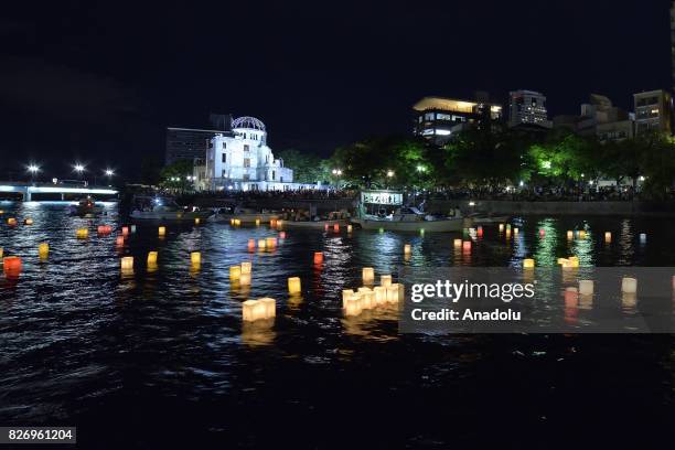 People attend the Peace Message Lantern Floating Ceremony held to console the souls of the A-Bomb victims after the Hiroshima Peace Memorial Ceremony...