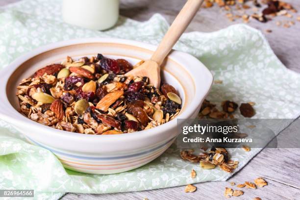 homemade granola or muesli with toasted almonds, raisin, cranberry in a bowl for healthy breakfast, selective focus - oatmeal raisin stock pictures, royalty-free photos & images