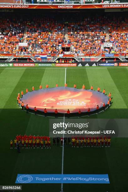 The teams of Netehrlandfs and Denmark stand for the national anthem during the UEFA Women's Euro 2017 Final between Denmark and Netherlands at De...