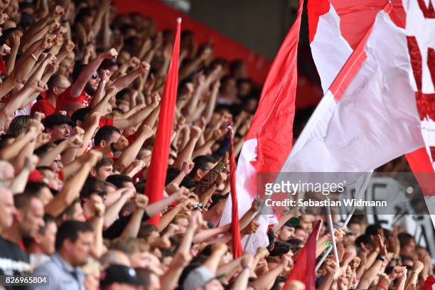 Supporters of SSV Jahn Regensburg raise their fists before the Second Bundesliga match between SSV Jahn Regensburg and 1. FC Nuernberg at Continental...