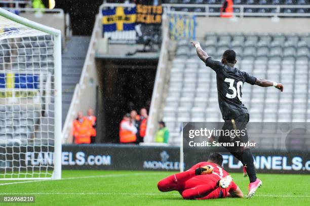 Christian Atsu of Newcastle United scores the second goal past Hellas Verona Goalkeeper Nicholas during the Pre Season Friendly match between...