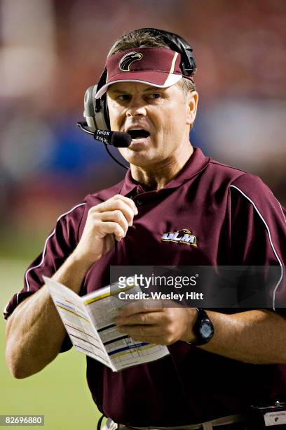 Head Coach Charlie Weatherbie of the Louisiana-Monroe Warhawks signals in a play during a game against the Arkansas Razorbacks at War Memorial...