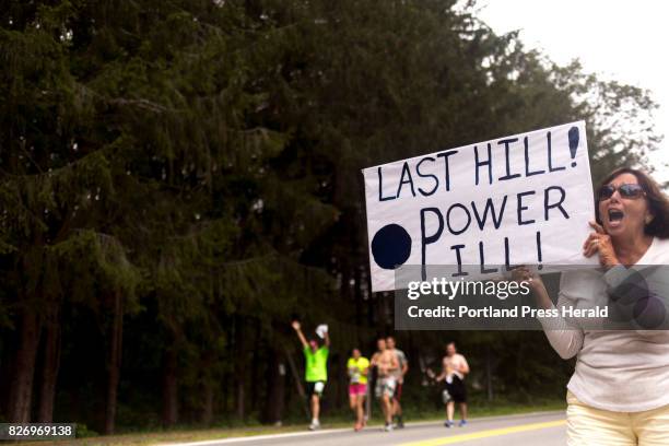 Meg Robinson, of Cape Elizabeth, encourages runners up their last hill before enter Fort Williams Park during the 20th annual TD Beach to Beacon 10K.