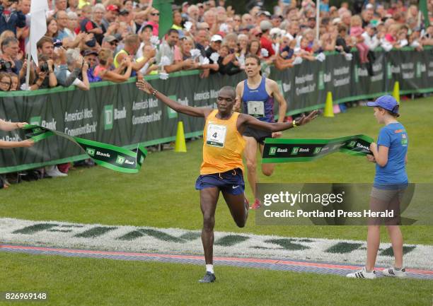 Stephen Kosgei Kibet crosses the finish line with a time of 27 minutes, 55 seconds to win the TD Beach to Beacon 10K road race in Cape Elizabeth on...