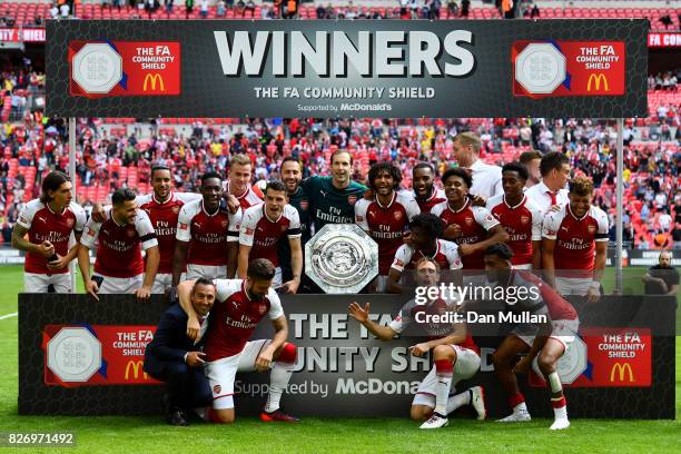 Arsenal team celebrate with the trophy following the The FA Community Shield final between Chelsea and Arsenal at Wembley Stadium on August 6, 2017...