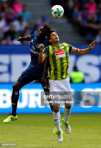 Bakery Jatta of Hamburg and Javier Lopez of RCD Espanyol jumo to head for the ball during the pre-season friendly match between Hamburger SV and RCD...