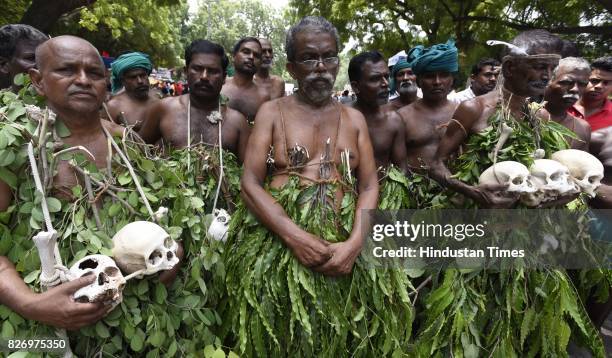Farmers from Tamil Nadu wear foliage and hold skulls as they speak of governments' apathy leading to mass suicides by farmers, at Jantar Mantar, on...