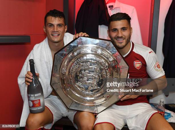 Arsenal's Granit Xhaka and Sead Kolasinac with the Community shield in the changing room after the FA Community Shield match between Chelsea and...