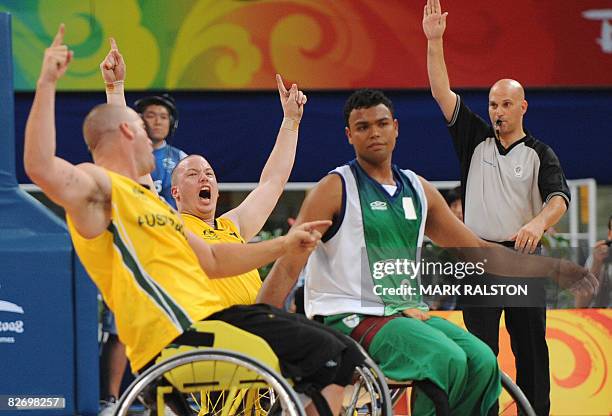 Shaun Norris of Australia celebrates with teammate Brad Ness as Irio Nunes of Brazil looks on at the end of their Group B basketball game at the 2008...