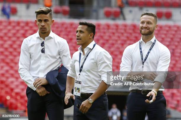 Arsenal's Brazilian defender Gabriel, , Arsenal's Chilean striker Alexis Sanchez and Arsenal's German defender Shkodran Mustafi look on after the...