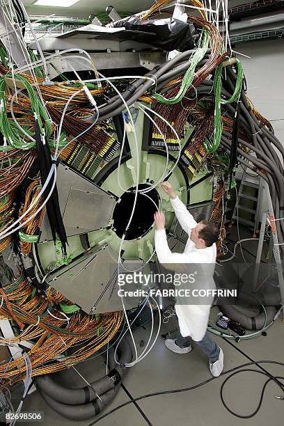Technician works on March 22, 2007 near Geneva, at the building of the cap of the world's largest superconducting solenoid magnet , one of the...