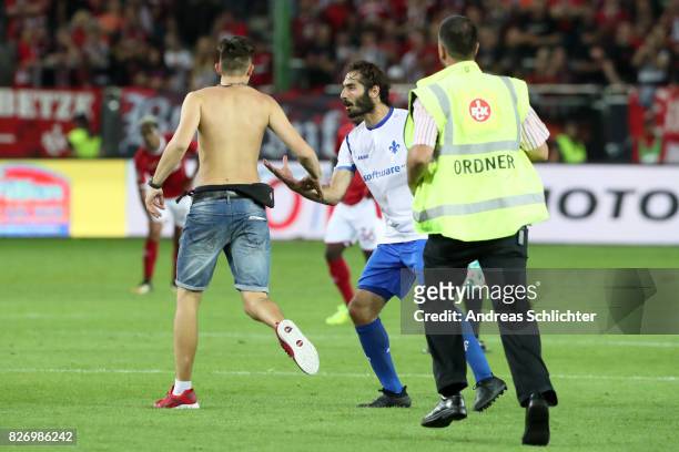 A streaker of kaiserslautern and Hamit Altintop of Darmstadt during the Second Bundesliga match between 1. FC Kaiserslautern and SV Darmstadt 98 at...