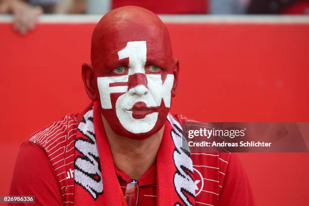 Fan with painted face of Kaiserslautern during the Second Bundesliga match between 1. FC Kaiserslautern and SV Darmstadt 98 at Fritz-Walter-Stadion...