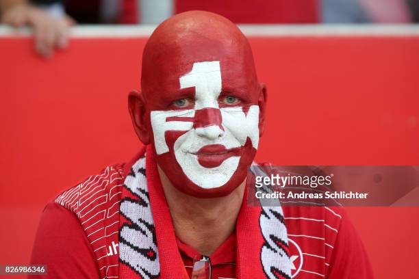 Fan with painted face of Kaiserslautern during the Second Bundesliga match between 1. FC Kaiserslautern and SV Darmstadt 98 at Fritz-Walter-Stadion...