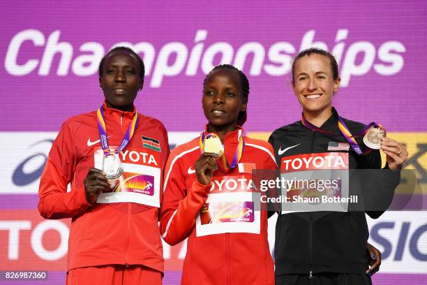 Edna Ngeringwony Kiplagat of Kenya poses with the silver medal, Rose Chelimo of Bahrain poses with the gold medal and Amy Cragg of the United States...