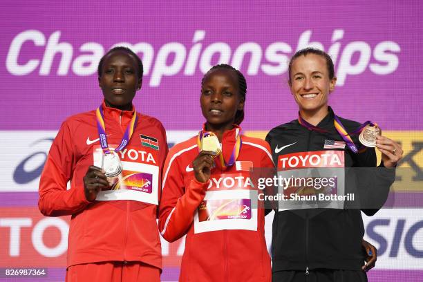 Edna Ngeringwony Kiplagat of Kenya poses with the silver medal, Rose Chelimo of Bahrain poses with the gold medal and Amy Cragg of the United States...