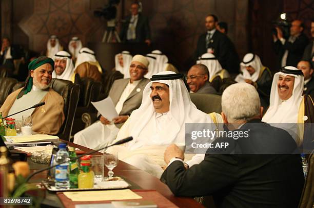 Qatar's Emir Sheikh Hamad bin Khalifa al-Thani laughs with Palestinian leader Mahmud ABbas , Comoros Islands President Ahmad Abdullah Sambi , Qatari...