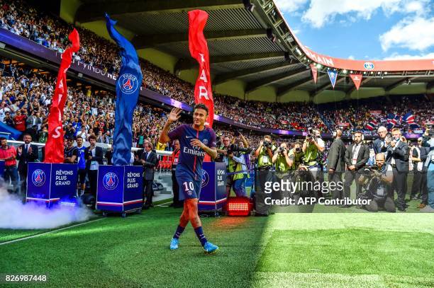 Paris Saint-Germain's Brazilian forward Neymar gestures as his arrives during his presentation to the fans at the Parc des Princes stadium in Paris...