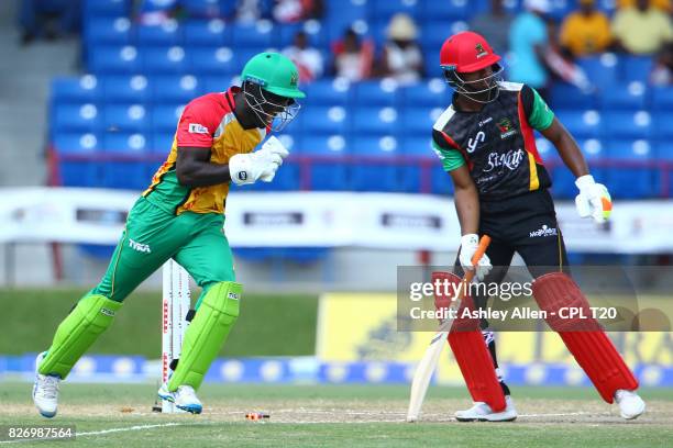 In this handout image provided by CPL T20, Chadwick Walton Guyana Amazon Warriors celebrate the dismissal of Evin Lewis of the St Kitts and Nevis...