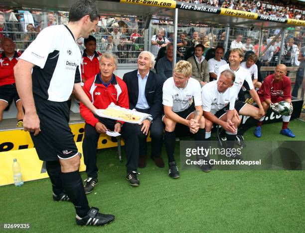 Markus Merk offers Rainer Bonhof, Rudi Voeller, Stefan Effenberg, Andi Brehme and Guido Buchwald of Germany and the rest of the world cake before the...