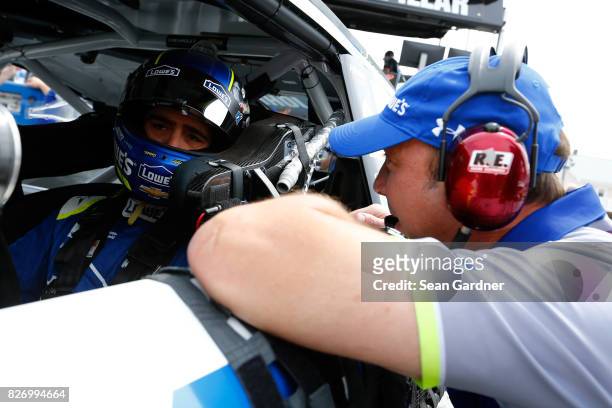 Jimmie Johnson, driver of the Lowe's Chevrolet, talks with crew chief Chad Knaus during qualifying for the Monster Energy NASCAR Cup Series I Love NY...