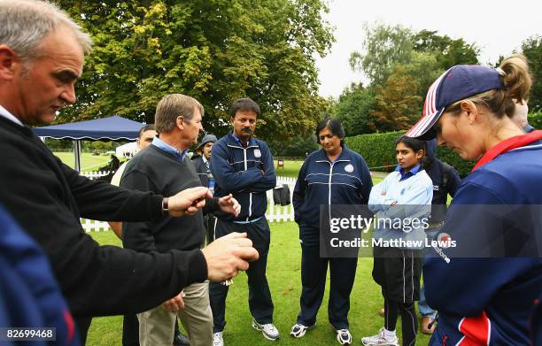 Umpires Peter Hartley and Trevor Jesty discuss with Mithali Raj, captain of India and Charlotte Edwards, captain of England the state of play during...