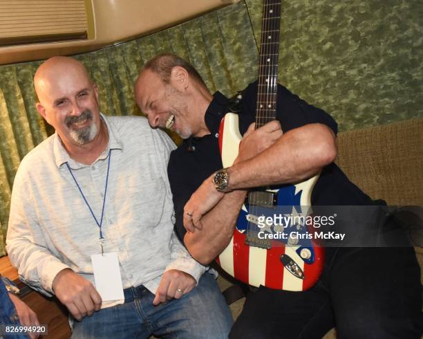 Peter Holsapple and Wayne Kramer relax backstage during the Artist2Artist Benefit For Homeless Veterans at The Office on August 5, 2017 in Athens,...