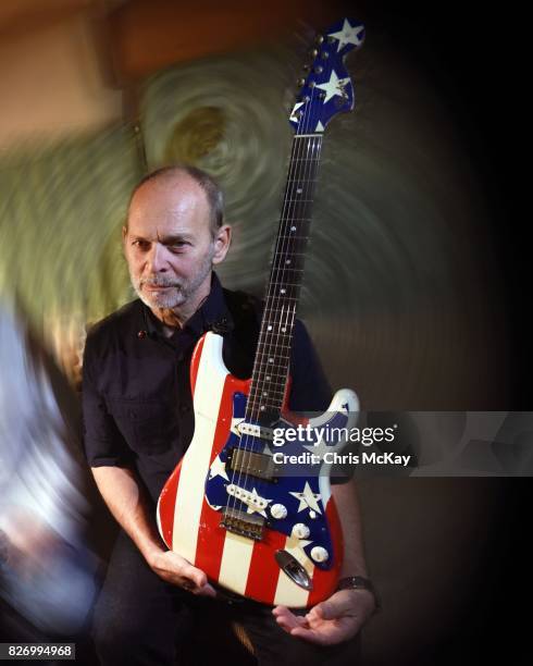 Wayne Kramer from The MC5 waits backstage with his famous American Flag Fender Stratocaster before performing at the Artist2Artist Benefit For...