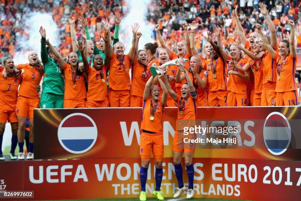 Mandy van den Berg of the Netherlands and Sherida Spitse of the Netherlands lift the trophy following the Final of the UEFA Women's Euro 2017 between...