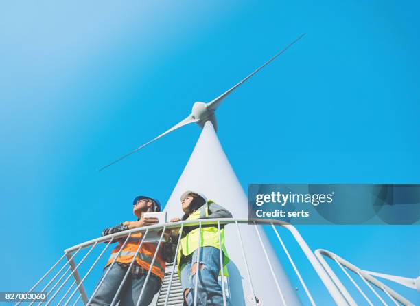 maintenance engineers working on wind turbine in windfarm - offshore windfarm stock pictures, royalty-free photos & images