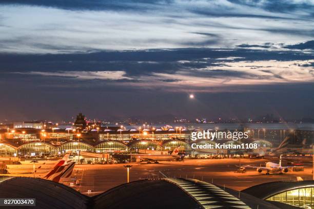 hong kong airport during the evening - hong kong international airport stock pictures, royalty-free photos & images