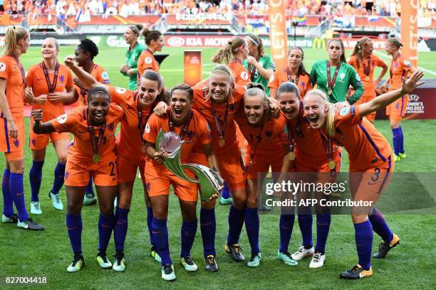 Netherlands' team players celebrate with the trophy after winning the UEFA Womens Euro 2017 football tournament final match between Netherlands and...