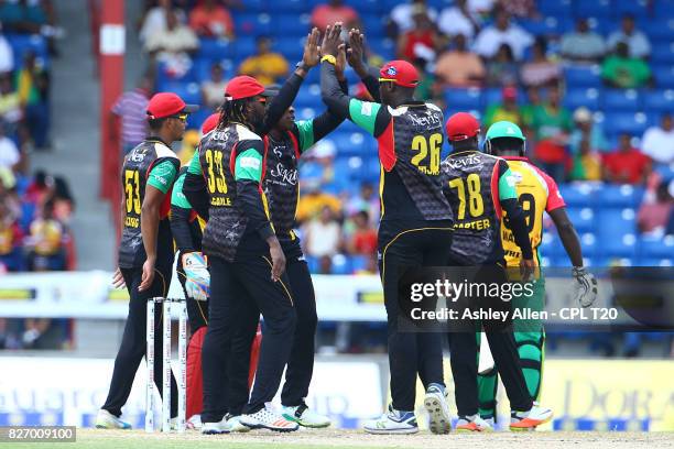 In this handout image provided by CPL T20, St Kitts and Nevis Patriots celebrate the dismissal of Chadwick Walton of the Guyana Amazon Warriors...