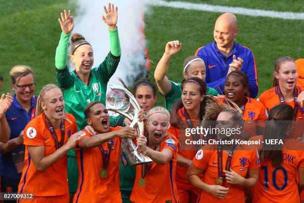 Shanice van de Sanden and Kika van Es of the Netherlands lift the trophy on the podium after winning the Netherlands v Denmark - UEFA Women's Euro...