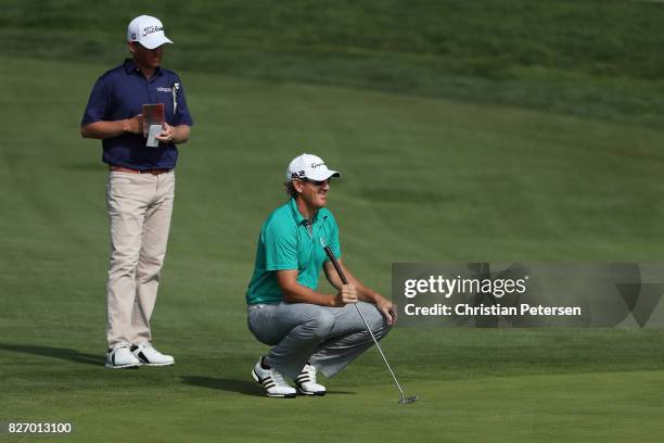 Greg Owen of England and Derek Fathauer line up putts on the first hole during the final round of the Barracuda Championship at Montreux Country Club...