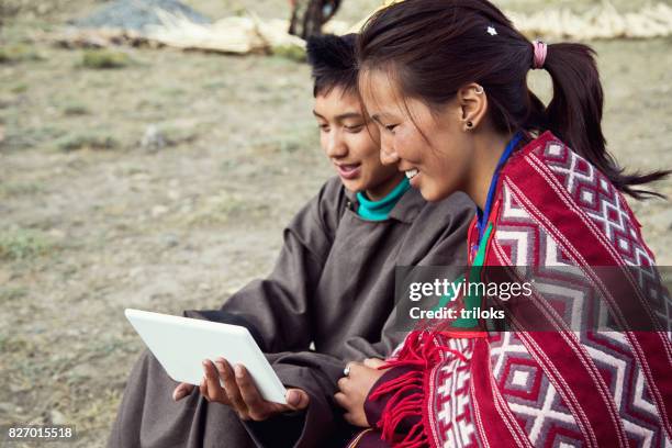 man and woman using digital tablet - india tribal people stock pictures, royalty-free photos & images