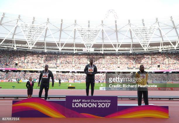 Christian Coleman of the United States, silver, Justin Gatlin of the United States, gold, and Usain Bolt of Jamaica, broze pose with their medals for...
