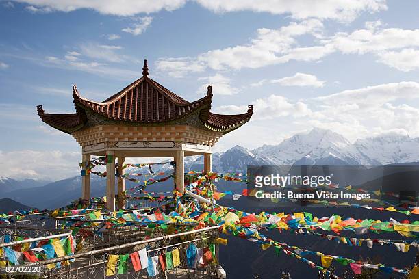 buddhist temple and flags - chinese temple stock-fotos und bilder