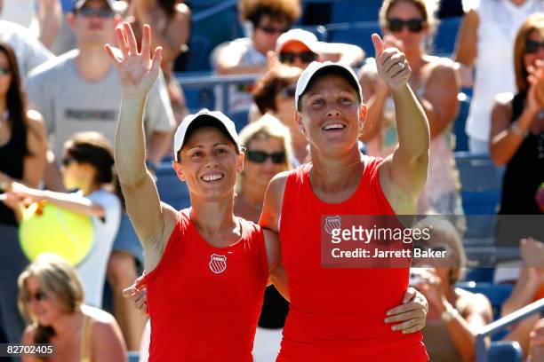 Cara Black of of Zimbabwe and Liezel Huber of the United States wave to the crowd after defeating Lisa Raymond of the United States and Samantha...