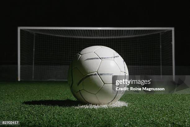 football in front of goal at night - örebro stock pictures, royalty-free photos & images