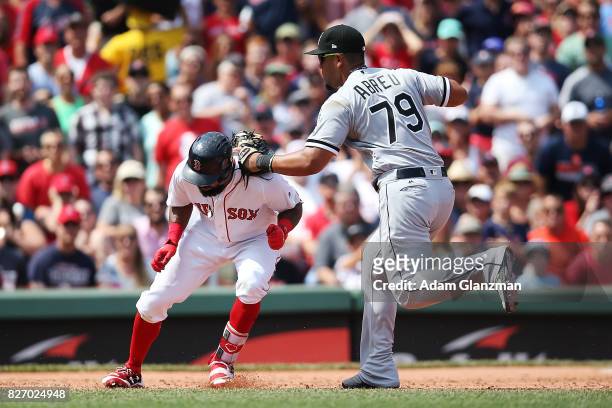 Chris Young of the Boston Red Sox is tagged out by Jose Abreu of the Chicago White Sox during the third inning at Fenway Park on August 6, 2017 in...