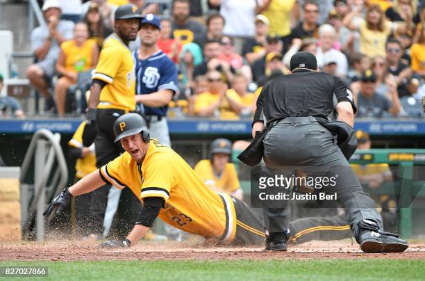 David Freese of the Pittsburgh Pirates slides into home plate on an RBI double by Jose Osuna in the third inning during the game against the San...