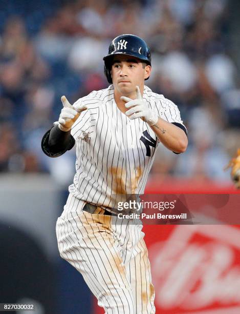 Tyler Wade of the New York Yankees gestures to teammates from second base after hitting a double in an MLB baseball game against the Detroit Tigers...