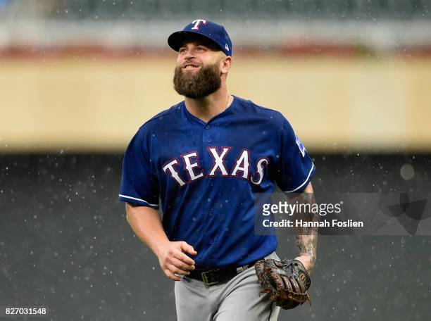 Mike Napoli of the Texas Rangers runs off the field as the game against the Minnesota Twins is delayed due to rain in the second inning on August 6,...