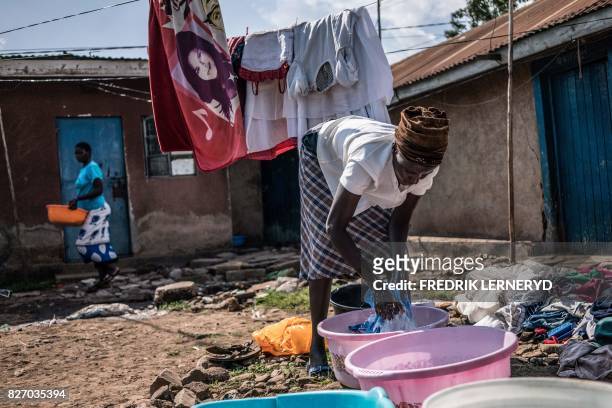 Mary does her family's laundry on August 5, 2017 in Obunga slum in the lakeside city of Kisumu, one of the hotspots during the 2007-2008...