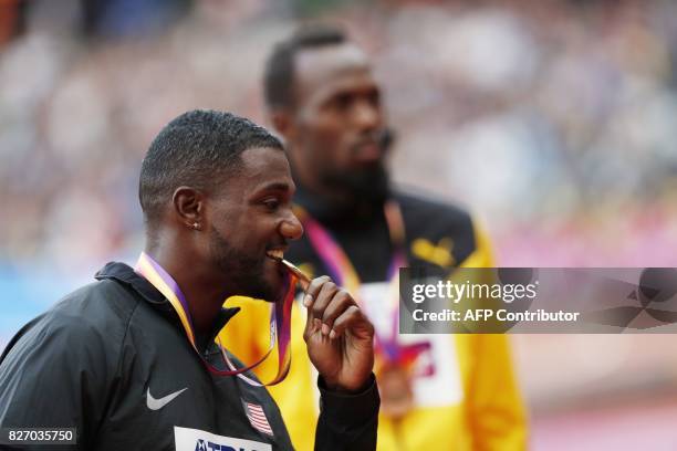 Gold medallist US athlete Justin Gatlin poses on the podium during the victory ceremony for the men's 100m athletics event at the 2017 IAAF World...